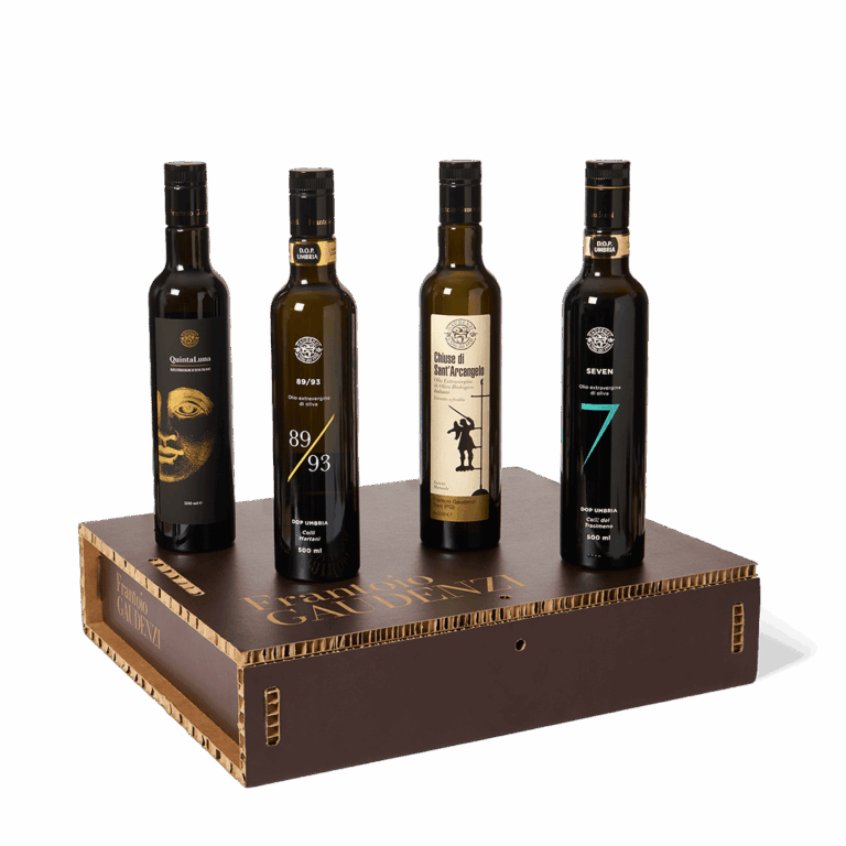 4 bottiglie di olio gaudenzi appoggiate sopra una scatola